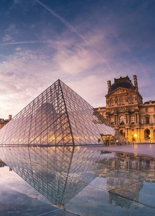 Louvre Museum courtyard with I.M. Pei pyramid showing scale contrast, symmetry, and clean architectural lines